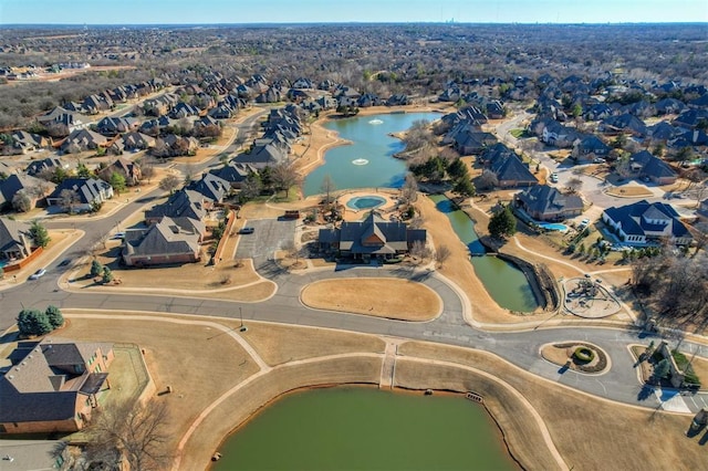 birds eye view of property with a water view and a residential view