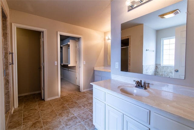 bathroom with tile patterned flooring, vanity, visible vents, and baseboards