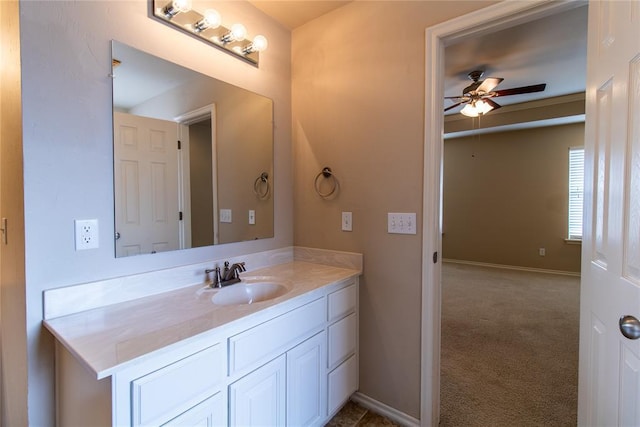 bathroom with ceiling fan, vanity, and baseboards