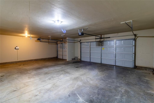 garage featuring a garage door opener and baseboards