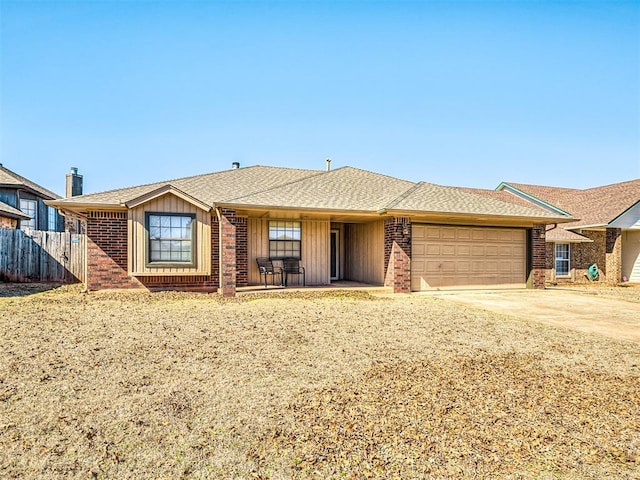 single story home featuring a garage, concrete driveway, brick siding, and fence