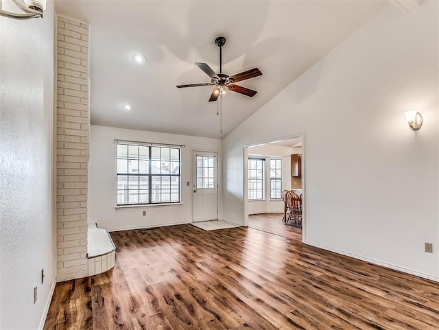 interior space featuring ceiling fan, vaulted ceiling, and wood finished floors