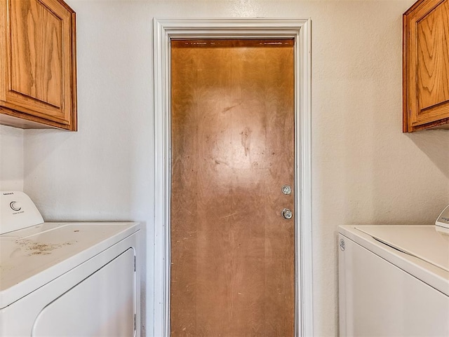 laundry area featuring cabinet space and independent washer and dryer