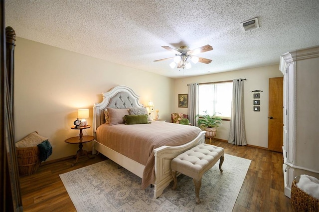 bedroom with visible vents, ceiling fan, a textured ceiling, and wood finished floors