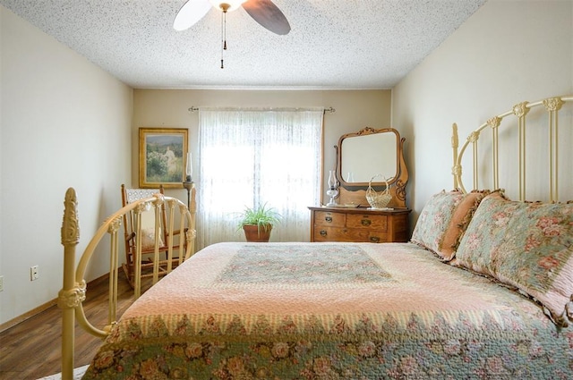 bedroom featuring a ceiling fan, a textured ceiling, and wood finished floors