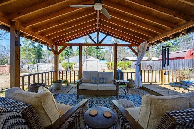 exterior space featuring a storage shed, a fenced backyard, an outdoor living space, and an outdoor structure