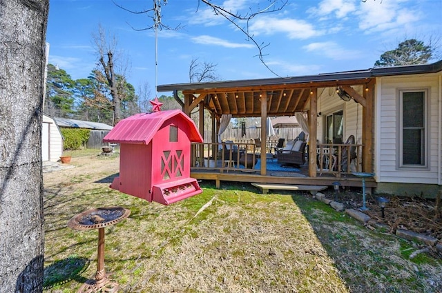 view of yard with a storage unit, a deck, and an outbuilding