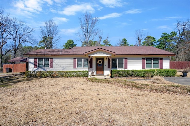 ranch-style home with fence