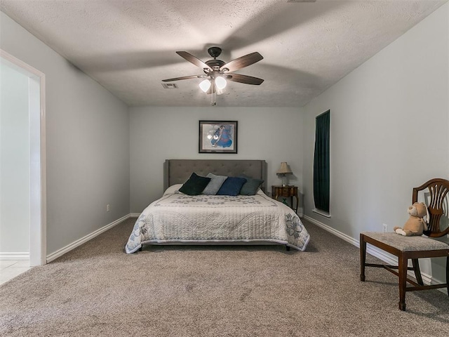 bedroom featuring carpet, visible vents, a textured ceiling, and baseboards