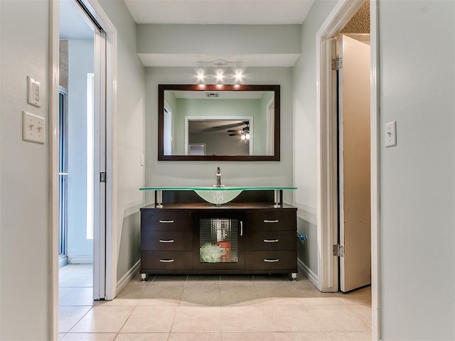 bathroom with tile patterned flooring, ceiling fan, vanity, and baseboards