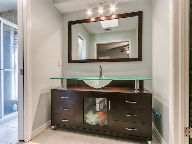 bathroom featuring tile patterned floors, baseboards, visible vents, and vanity