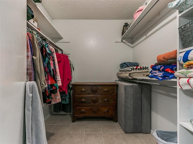 spacious closet with tile patterned floors