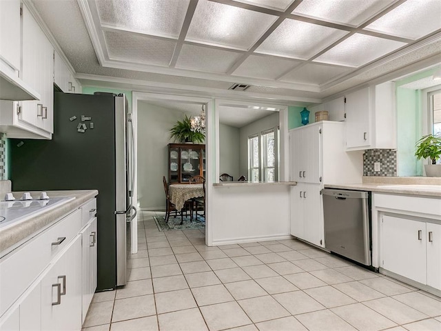 kitchen with light countertops, decorative backsplash, white cabinets, coffered ceiling, and dishwasher