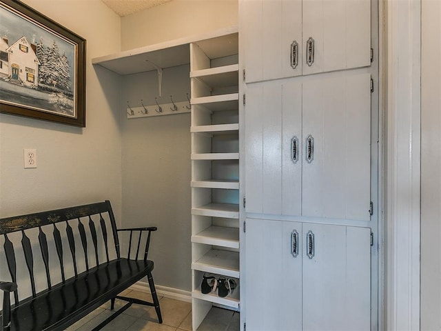 interior space with baseboards and tile patterned floors