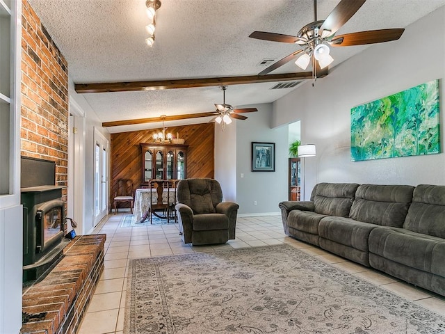 living room with wooden walls, visible vents, lofted ceiling with beams, a textured ceiling, and light tile patterned flooring