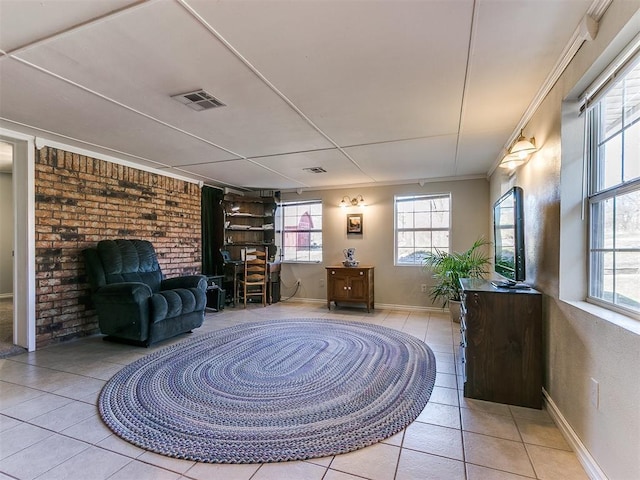 sitting room with ornamental molding, tile patterned flooring, visible vents, and baseboards