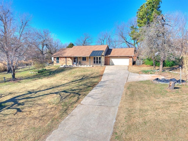 ranch-style house with concrete driveway, an attached garage, covered porch, a front lawn, and brick siding