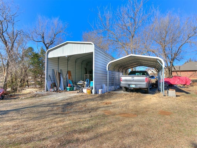 view of outbuilding featuring driveway and a detached carport