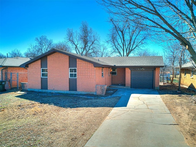 view of front of property with a garage, brick siding, a shingled roof, fence, and driveway