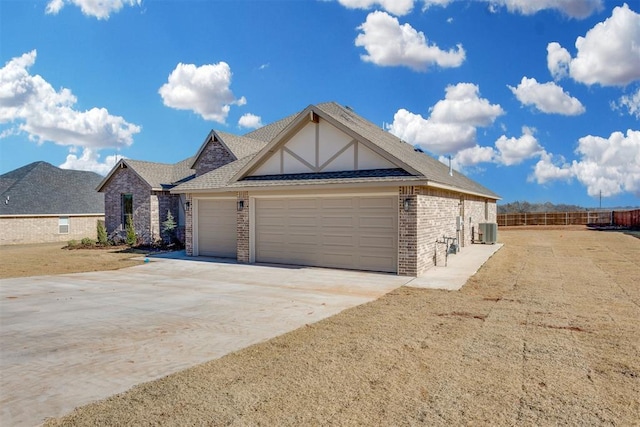 view of front of property featuring cooling unit, a garage, brick siding, fence, and concrete driveway