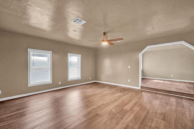 interior space with visible vents, baseboards, and wood finished floors