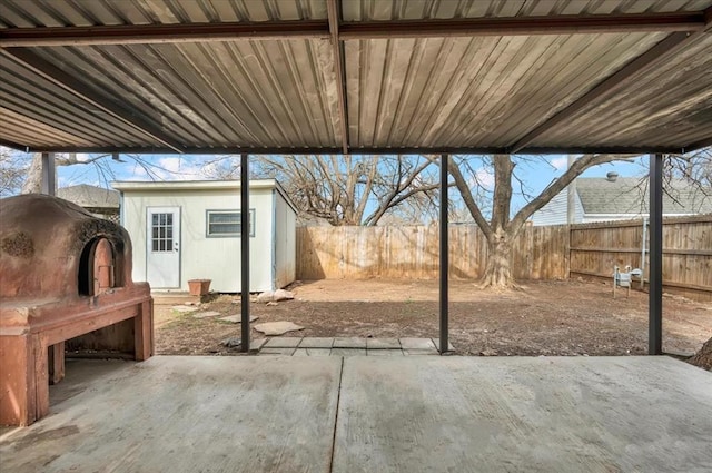 view of patio / terrace featuring an outdoor structure and a fenced backyard