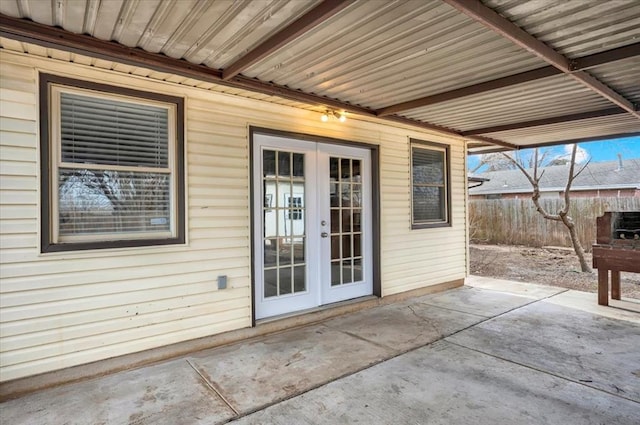 doorway to property with french doors, a patio area, and fence