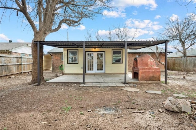 back of property featuring fence private yard, french doors, and a patio area