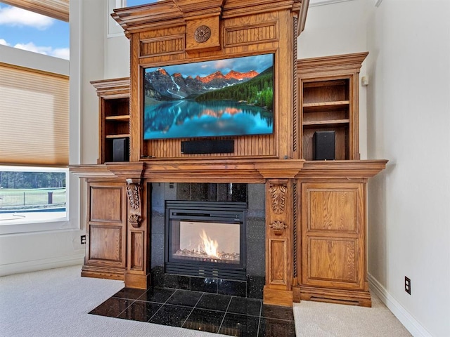 details featuring baseboards, carpet flooring, and a tile fireplace