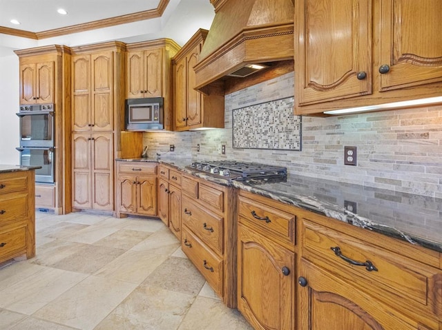 kitchen featuring appliances with stainless steel finishes, brown cabinetry, custom exhaust hood, and crown molding