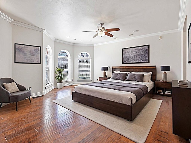 bedroom with dark wood-type flooring, ornamental molding, a ceiling fan, a textured ceiling, and baseboards