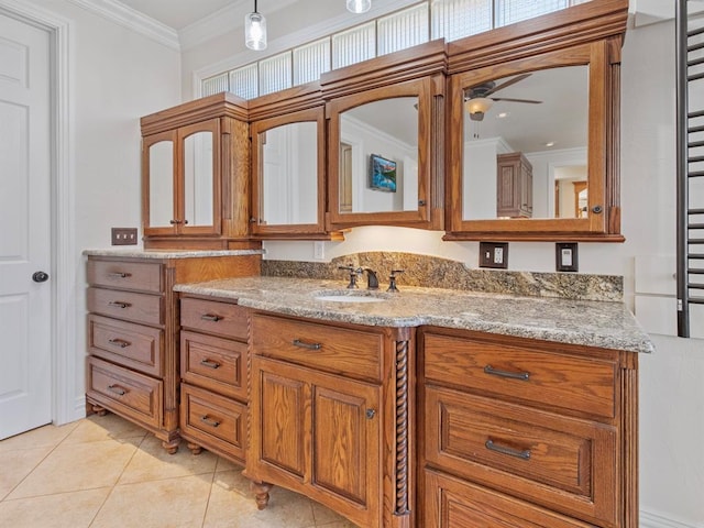 bathroom featuring tile patterned flooring, ornamental molding, a ceiling fan, and vanity