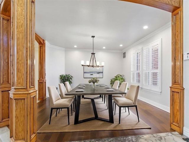 dining area featuring an inviting chandelier, baseboards, ornamental molding, and wood finished floors