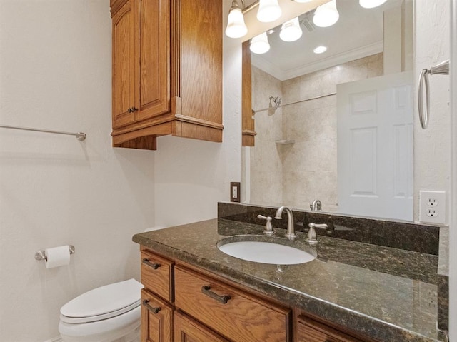 bathroom featuring ornamental molding, a tile shower, vanity, and toilet