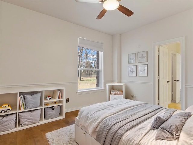 bedroom with baseboards, a ceiling fan, and wood finished floors