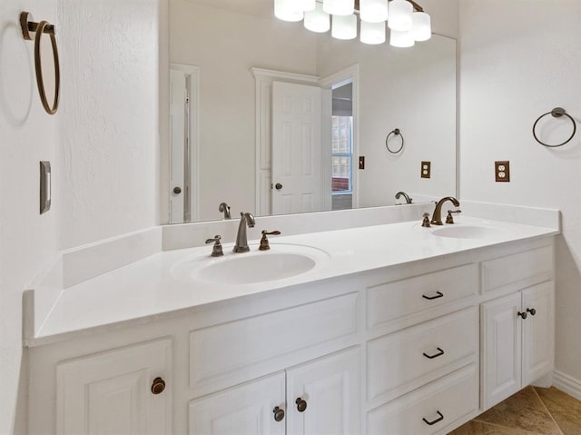 full bathroom with double vanity, a sink, and tile patterned floors