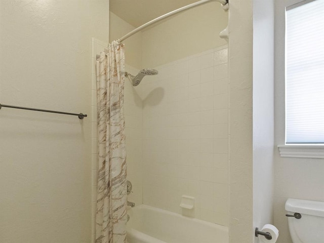 bathroom with toilet and shower / bathtub combination with curtain