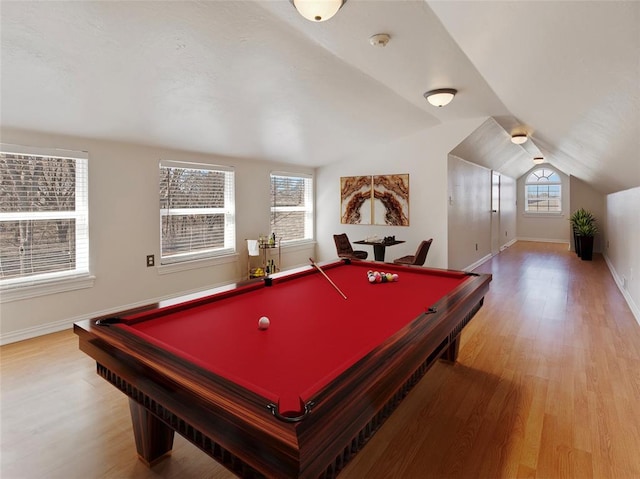 recreation room with lofted ceiling, baseboards, and wood finished floors