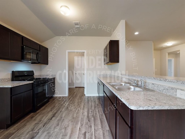 kitchen with black appliances, visible vents, light countertops, and a sink