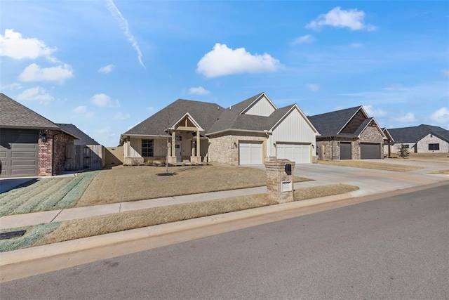 view of front facade featuring driveway, a garage, fence, and board and batten siding