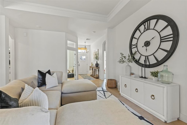 living room featuring light wood-style flooring and a chandelier