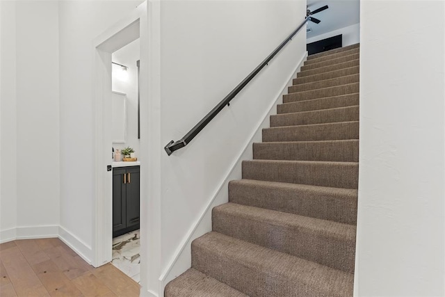 stairs featuring baseboards and wood finished floors