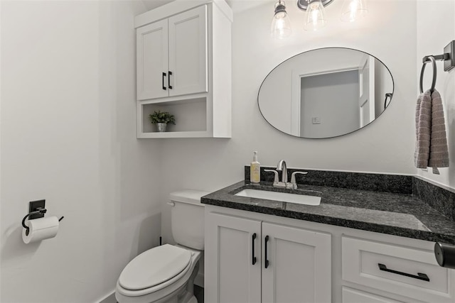 half bathroom with vanity and toilet