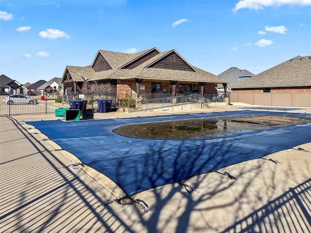 community pool featuring fence and a patio