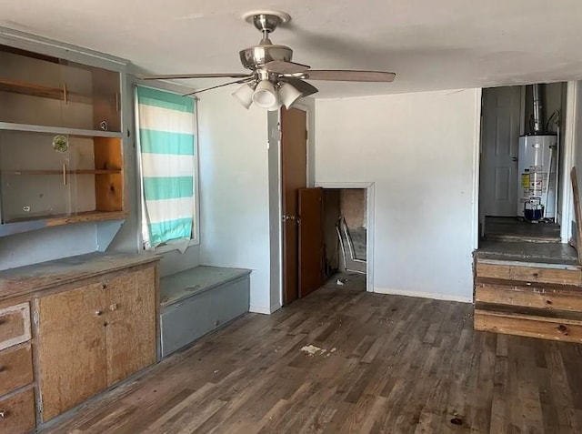 interior space with gas water heater, dark wood finished floors, and ceiling fan