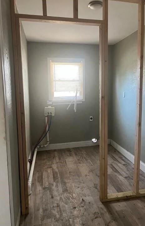 interior space featuring baseboards and wood finished floors