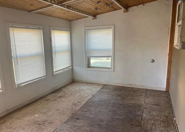 empty room featuring wooden ceiling