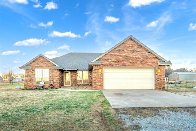 ranch-style house with brick siding, a shingled roof, a front yard, driveway, and an attached garage