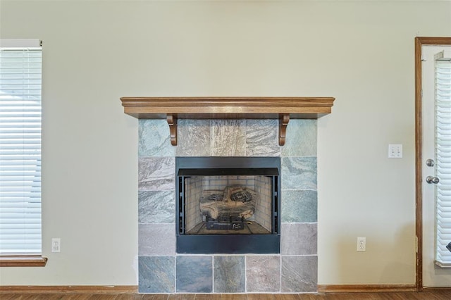 interior details featuring a fireplace and baseboards