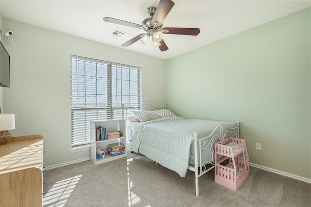 carpeted bedroom with a ceiling fan, baseboards, and visible vents